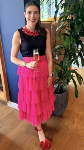 Handmade by Tinni Stella Necklace in fuchsia and red styled with navy British wool dress and pink tulle skirt